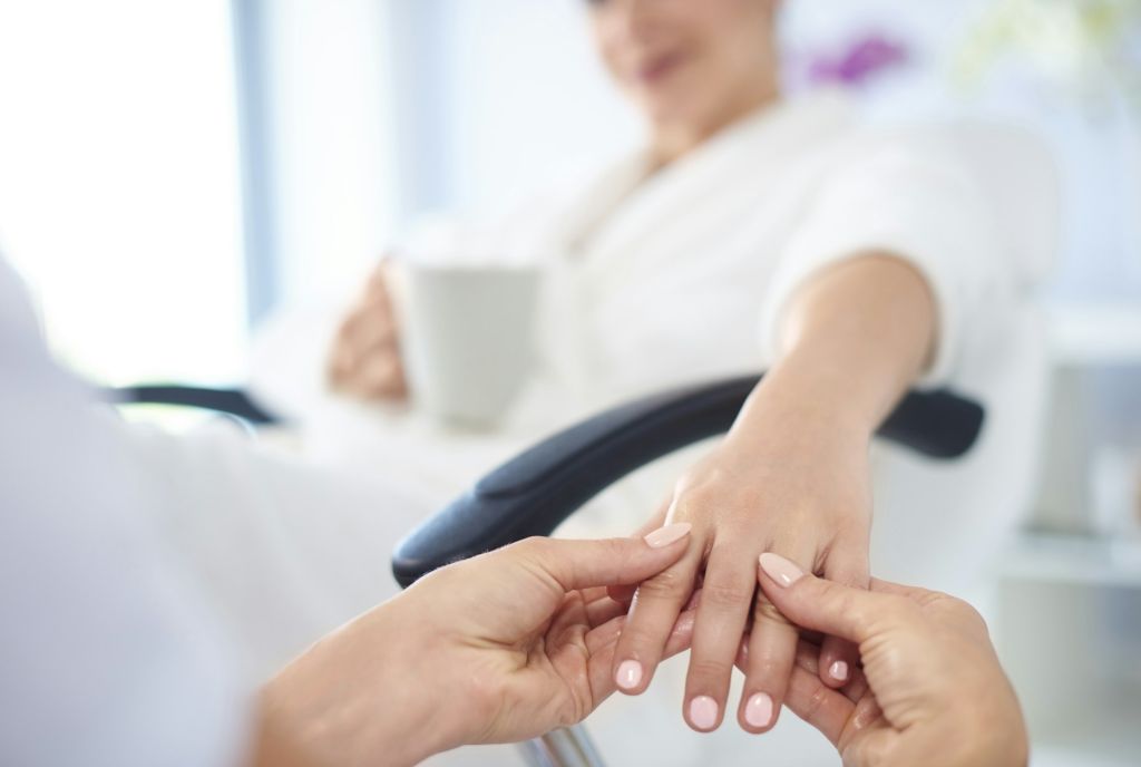 Young woman having spa manicure