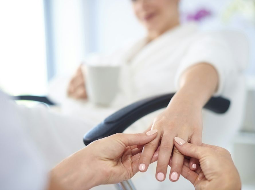 Young woman having spa manicure