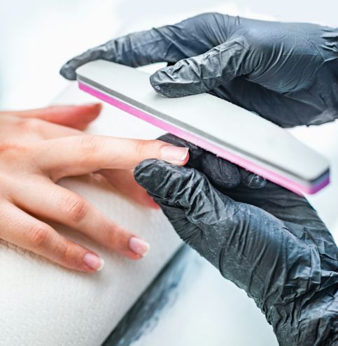 Filing fingernails at nail salon Filing fingernails at nail salon