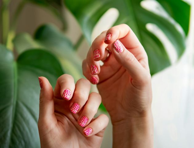 Hands with pink neon stamping nails manicure Hands with pink neon stamping nails manicure