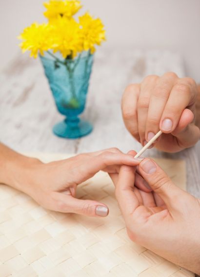 Manicurist cleaning a customers nails at a nail salon Manicurist cleaning a customers nails at a nail salon
